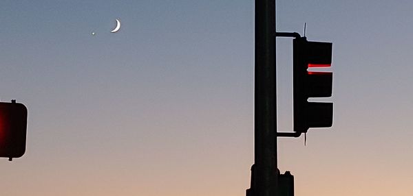 Low angle view of road sign against clear sky