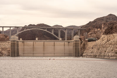 Bridge over river against sky during sunset