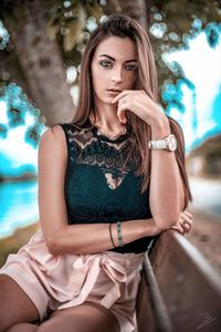 Portrait of young woman sitting outdoors