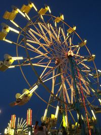 Low angle view of ferris wheel against sky