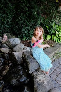 Girl sitting on rock