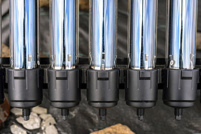 A modern pressure collector for heating domestic hot water, close-up on the ends of a vacuum tube.