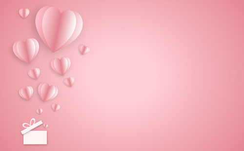 High angle view of heart shape over pink background