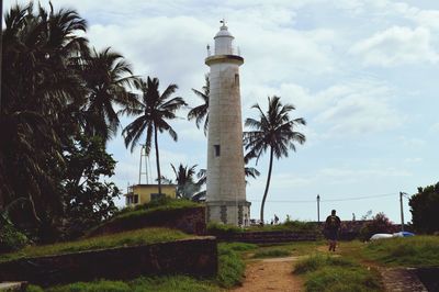 Rear view of man walking towards lighthouse at weligama