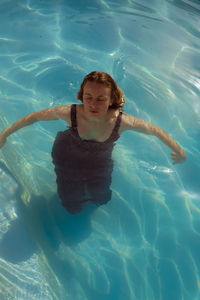 Portrait of woman swimming in pool