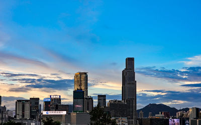 Modern buildings in city against sky