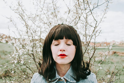 Portrait of woman against plants