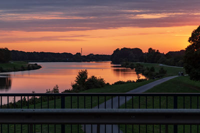 Scenic view of lake against orange sky