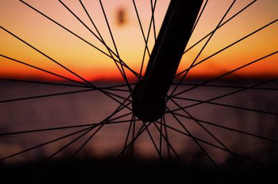 Close-up of silhouette bicycle during sunset