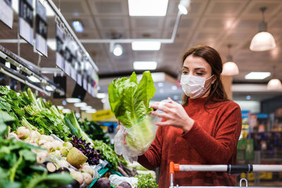 Woman wearing mask shopping at mall