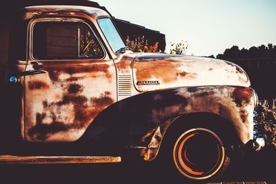 Old rusty car against sky