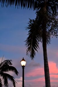 Low angle view of illuminated street light against sky at sunset