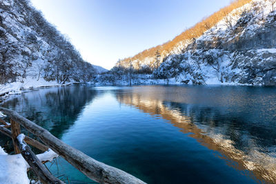 Scenic view of lake against sky during winter