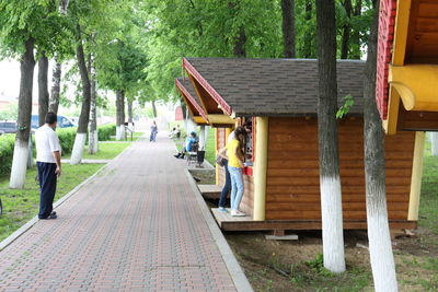 People on footpath amidst trees