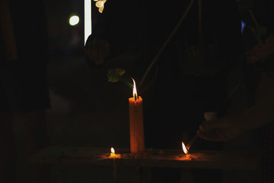 Lit candles in temple at night