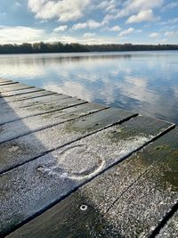 High angle view of footpath by lake against sky