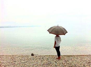 Rear view of man standing on beach