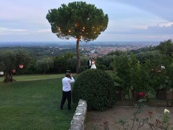 Rear view of man standing on tree