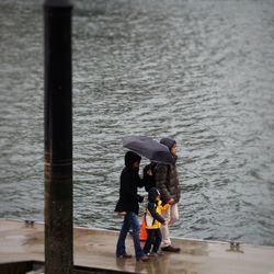 Man with umbrella at sea shore
