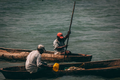 Men boating on sea