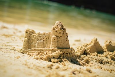 Close-up of stone on sand at beach