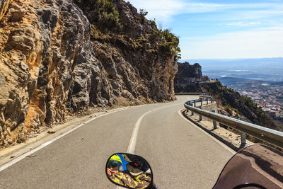 Road amidst rock formation against sky