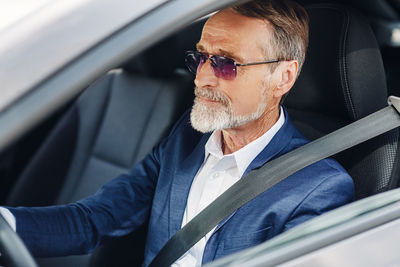 Midsection of man sitting in car