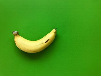 Close-up of bananas against green background