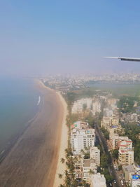 High angle view of sea and buildings against sky