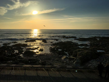 Scenic view of sea against sky at sunset