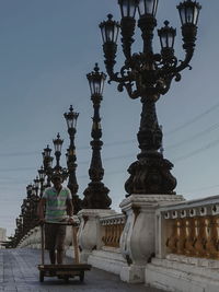 Rear view of people outside building against sky