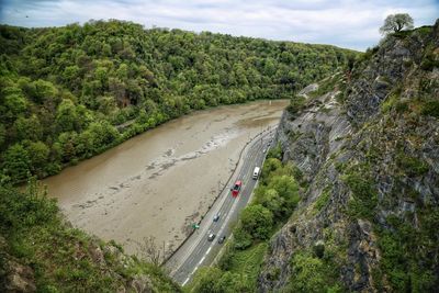 High angle view of road amidst trees against sky