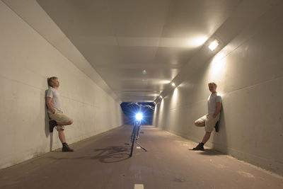 Double portrait of man standing in tunnel