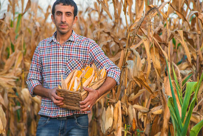 Portrait of young man standing in farm