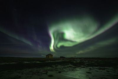 Scenic view of land against sky at night