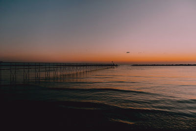 Scenic view of sea against clear sky during sunset