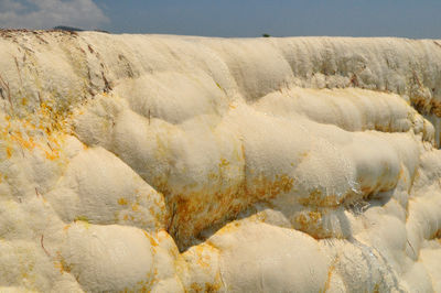 Scenic view of rocks on land against sky