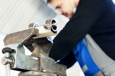 Midsection of worker working at factory