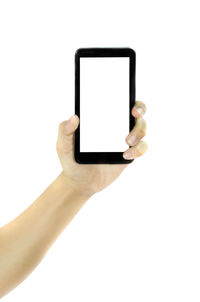 Low angle view of hand using mobile phone against white background