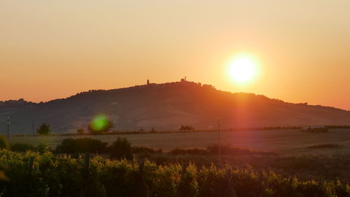 Scenic view of field against sky during sunset