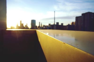 Close-up of city against sky during sunset