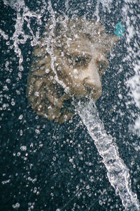 Close-up of water falling from statue