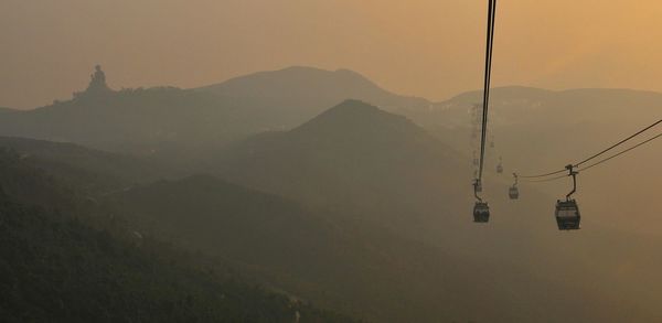 Scenic view of mountains against sky at sunset