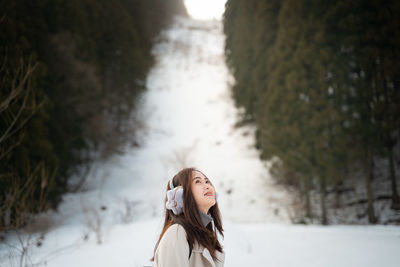 Woman looking away in snow