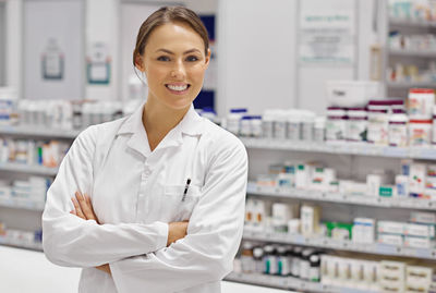 Portrait of pharmacist standing in store