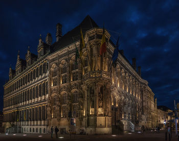 Low angle view of illuminated building against sky at night