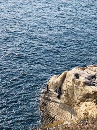 High angle view of rock formations on sea