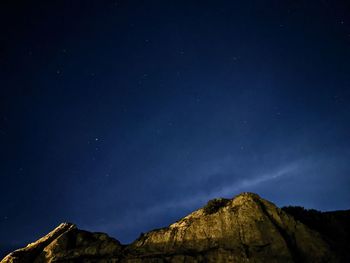 Low angle view of mountain against sky at night