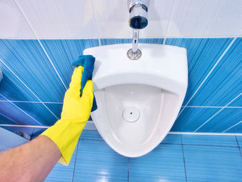 High angle view of woman washing hands in bathroom