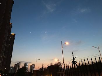 Low angle view of silhouette buildings against sky at sunset